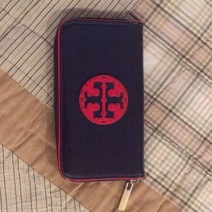 Tory Burch wallet with red trim.